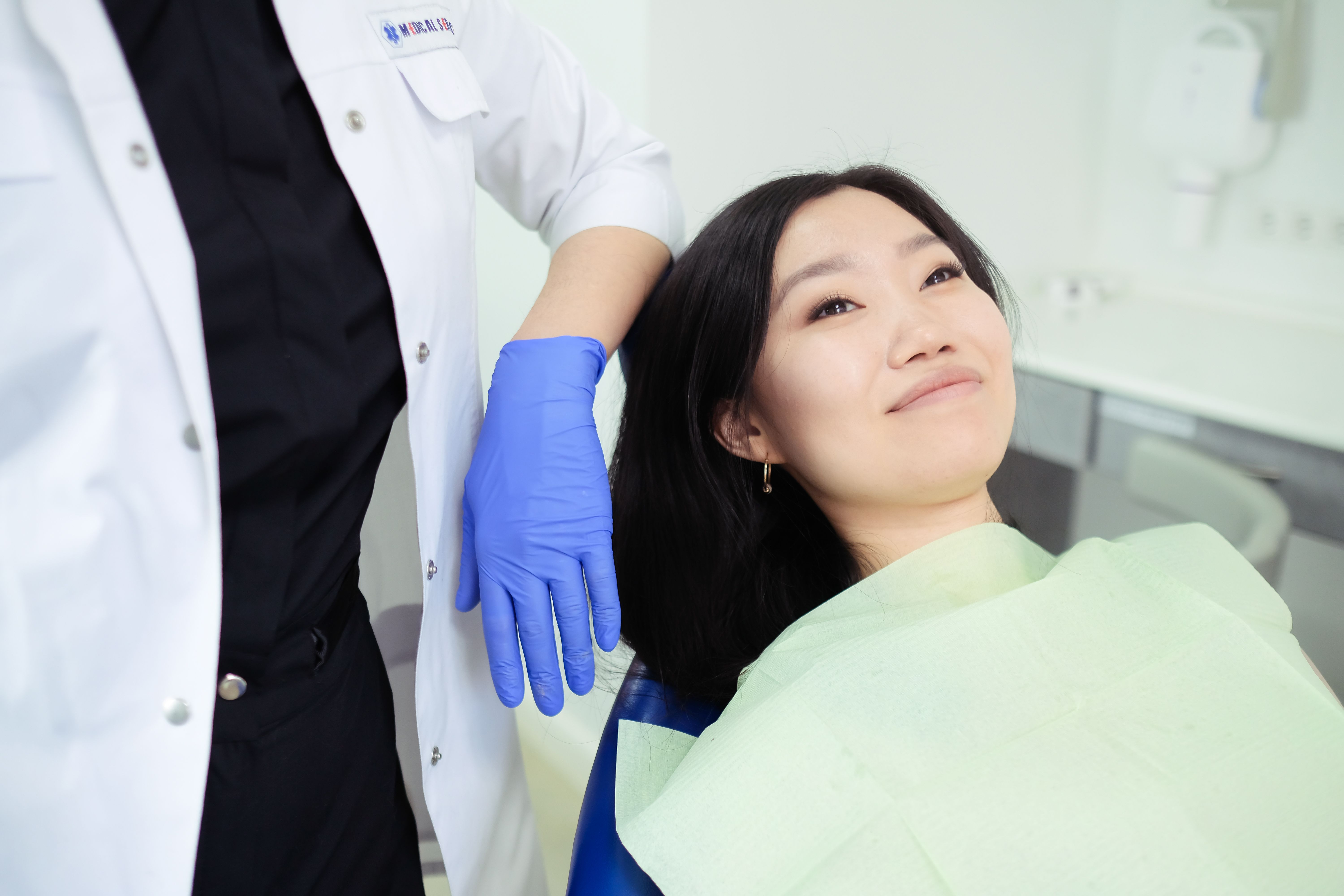 Smiling dental patient with a dentist in a modern clinic